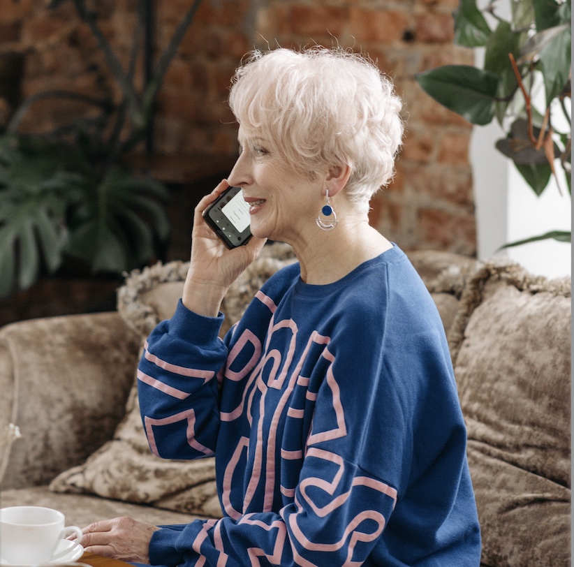Older woman smiling as she calls Elmes Homecare to arrange home care in Bromley