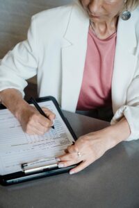 Elmes carer completing a home care plan and risk assessment